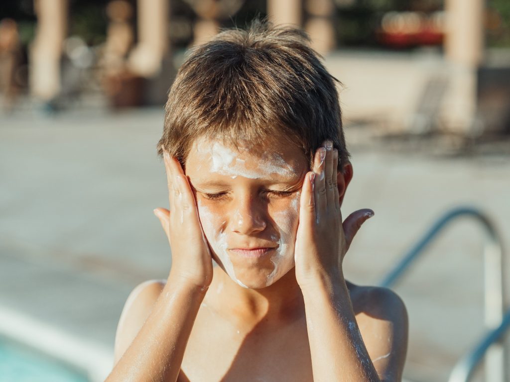 Kid Putting on Sunscreen