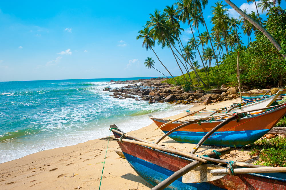 Untouched,Tropical,Beach,With,Palms,And,Fishing,Boats,In,Sri-lanka